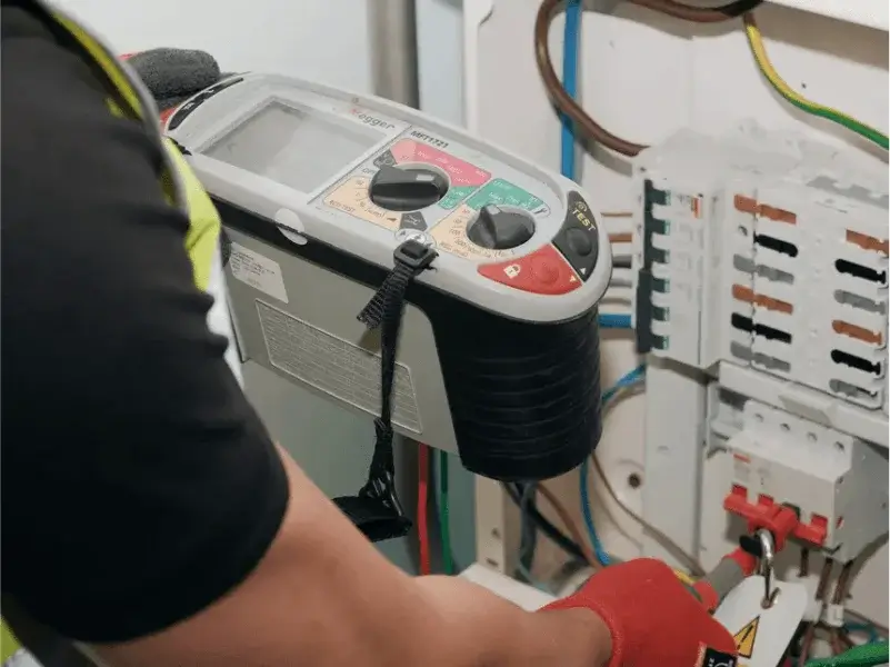 EICR Testing and Electrical Safety Reports – Peaks Electrical Bath Electrician carrying out EICR testing with diagnostic equipment on a fuse board in Bath.