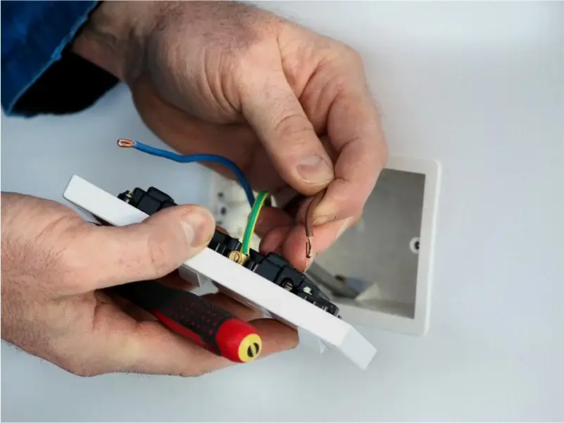 General Electrical Services – Qualified Electricians in Bath Qualified electrician wiring a UK power socket during a domestic installation in Bath.