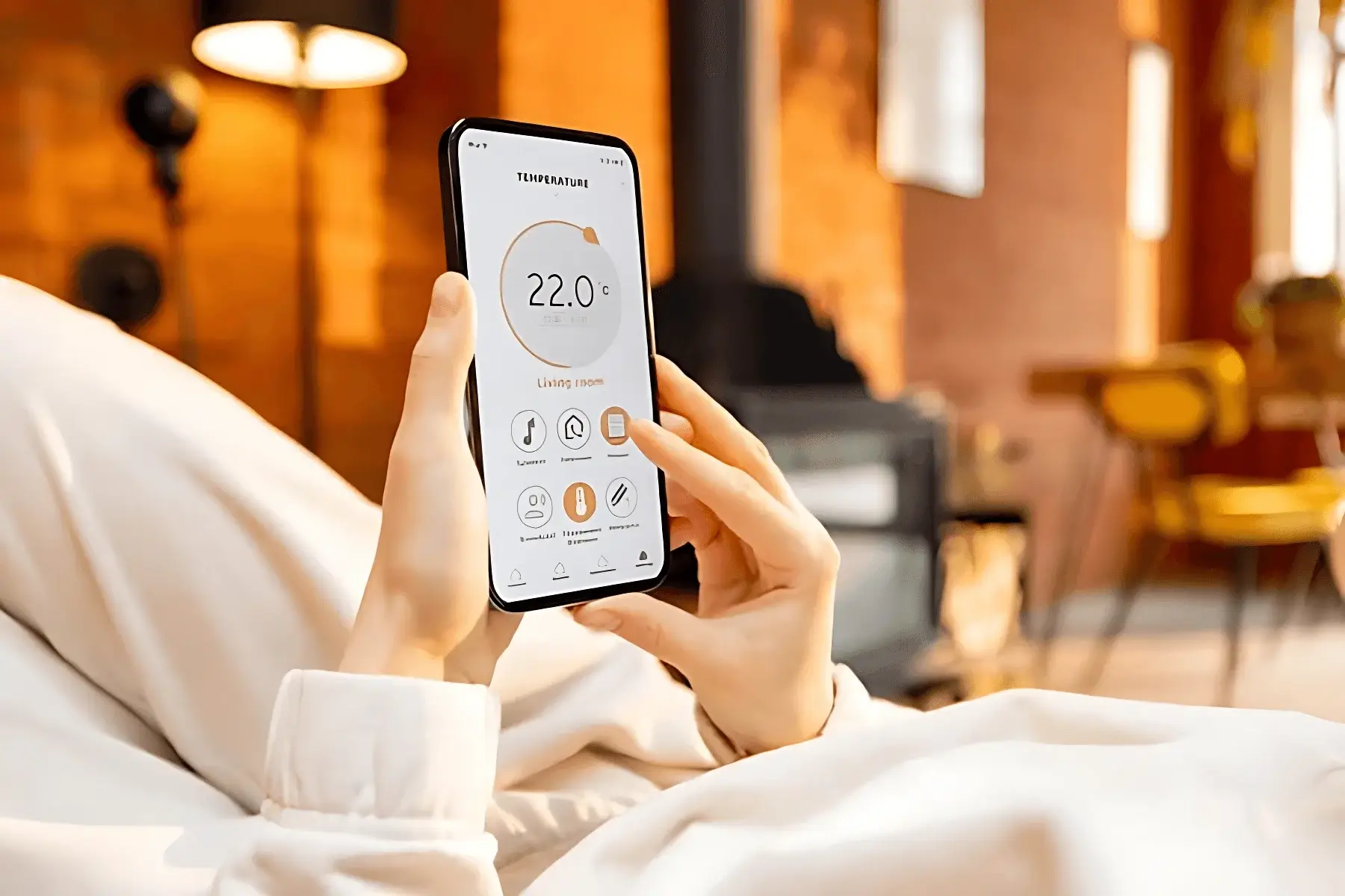 Person adjusting home temperature using a smart heating app on their phone, showing convenient climate control from the sofa.